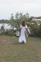 The Everyday Tote, a natural canvas boat tote with navy trim from The Homemaker's Club.